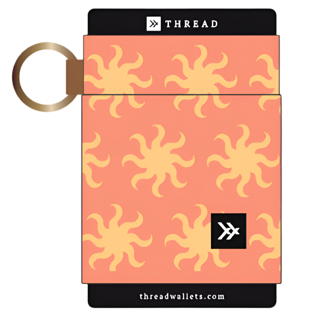 Thread elastic wallet in peach with yellow sunburst motifs and a gold keyring