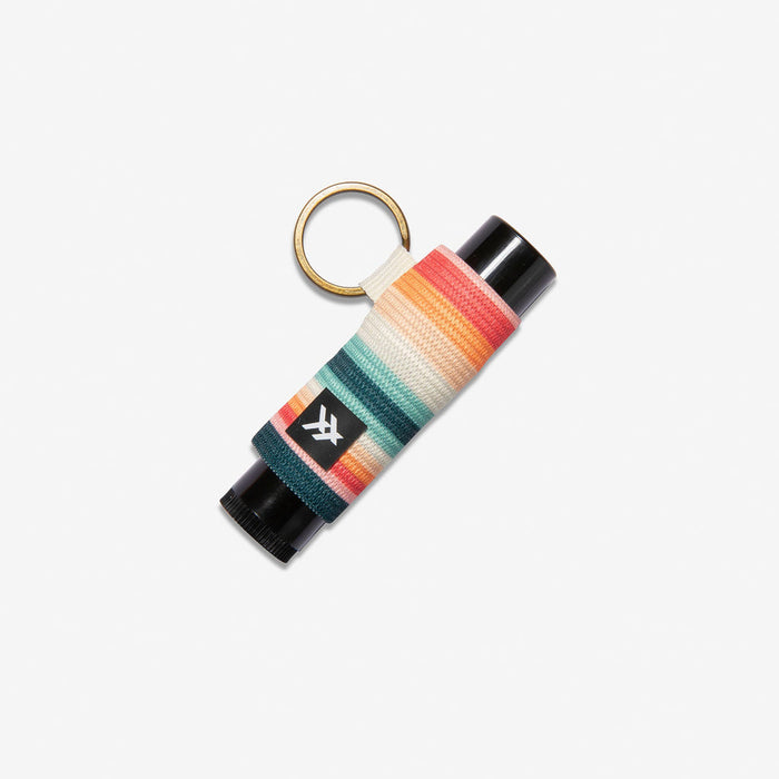 Lip balm holder wrapped in multicolor striped knit with a gold key ring
