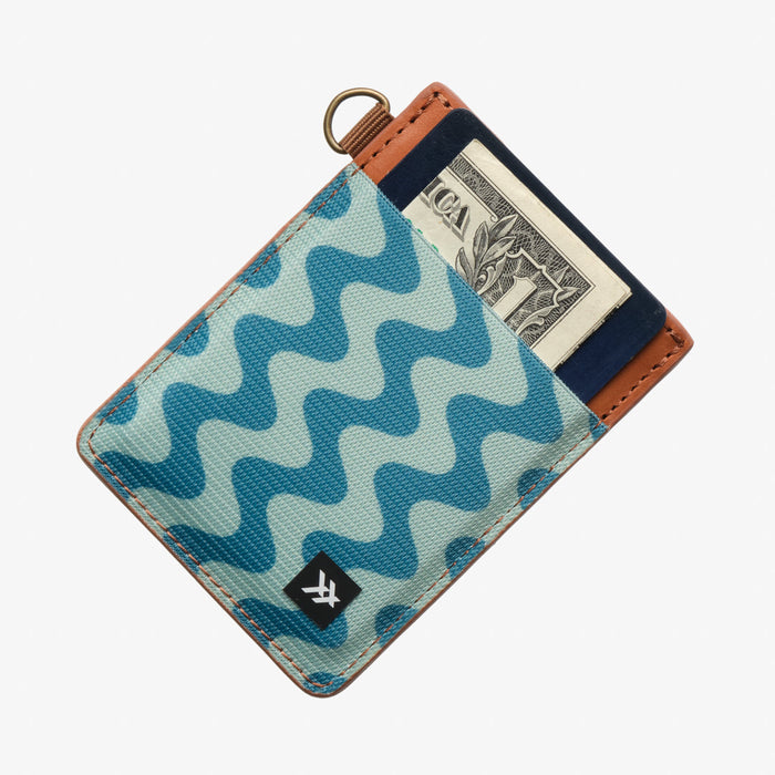 Thread Patterned vertical leather elastic wallet in teal zigzag pattern with tan edge and visible cash slot