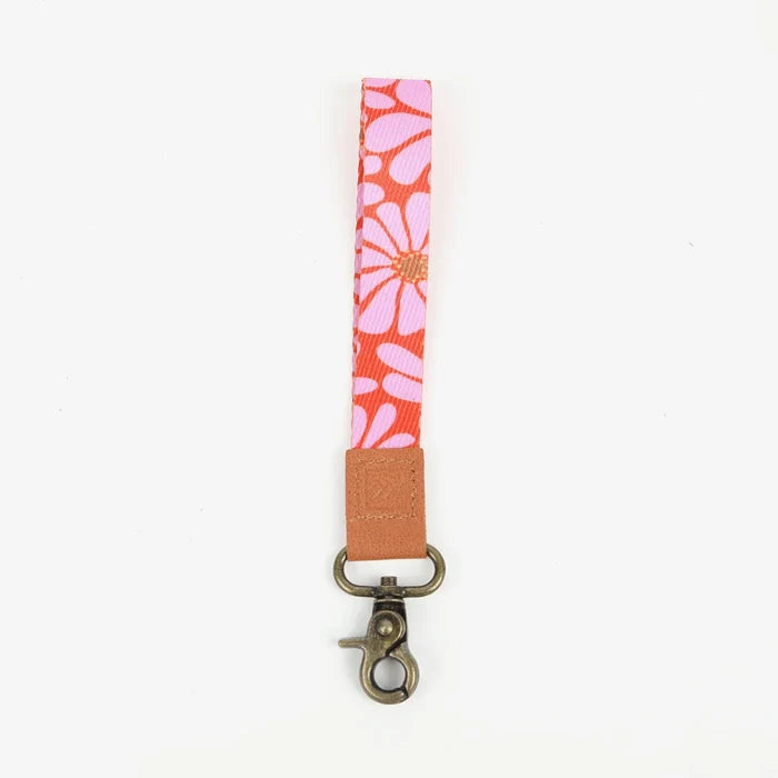 Pink floral wrist lanyard with tan leather tab and brass clip