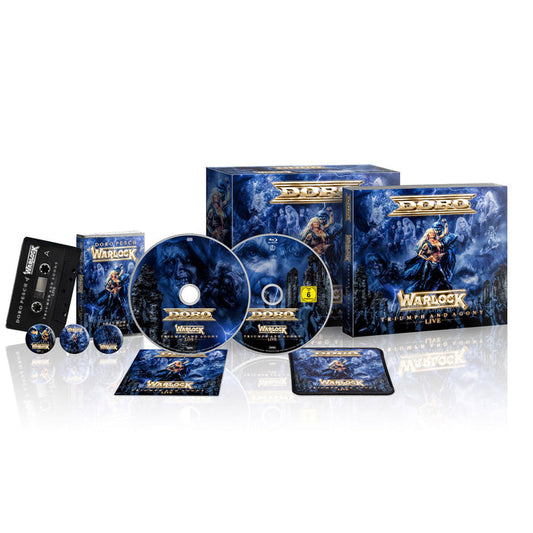 Doro box set for Warlock Live includes two boxes, a Digipak CD, Blu-ray, music cassette, buttons, a patch, and a booklet—all featuring blue fantasy-themed artwork of a warrior woman.