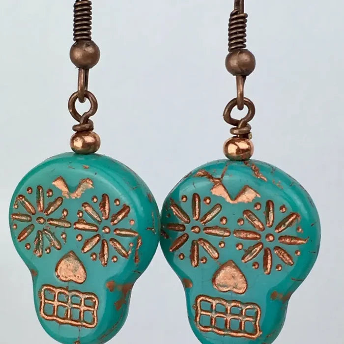 Pair of turquoise sugar skull dangle earrings with copper etched designs