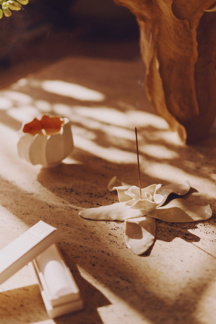 ULLA Luxury Incense Burning in Sun-Drenched Lifestyle Setting with Floral Ceramic Holder | Ulla Johnson
