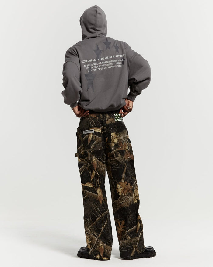 V1 CARPENTER PANTS REALTREE BLACK - black realtree camo carpenter pants, back view on male model - Cold Culture #man
