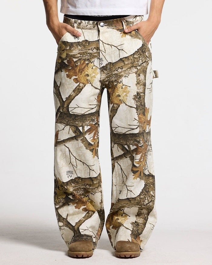 V1 CARPENTER PANTS REALTREE WHITE - white realtree camo carpenter pants, front view on male model - Cold Culture
