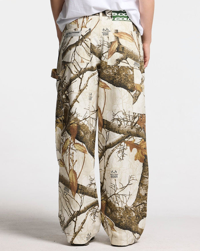 V1 CARPENTER PANTS REALTREE WHITE - white realtree camo carpenter pants, back view on female model - Cold Culture