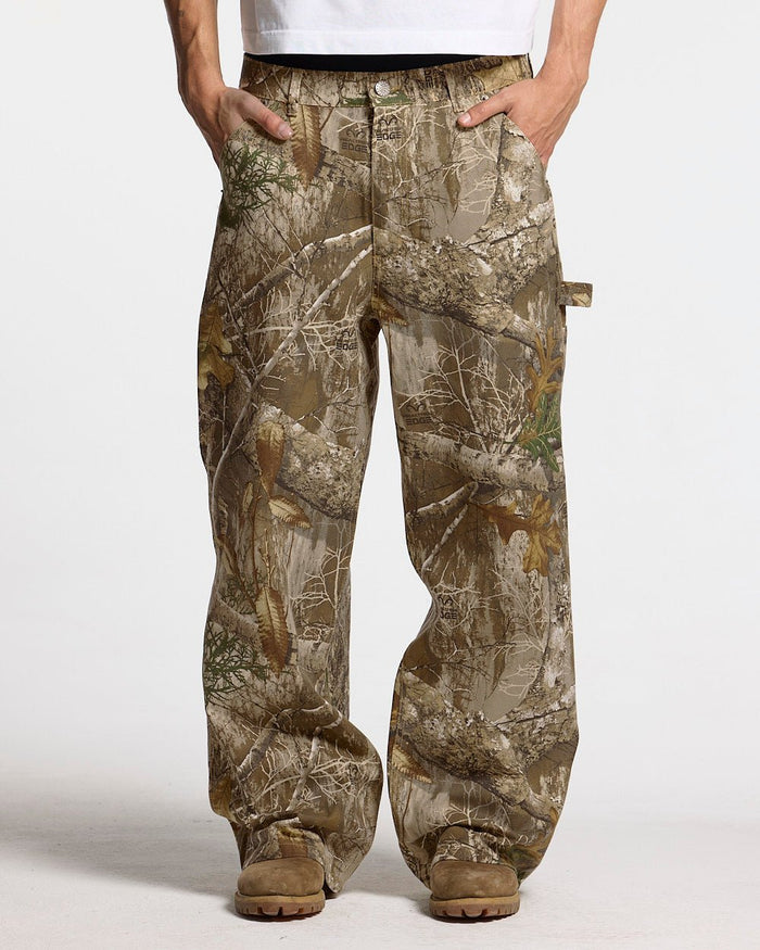 V1 CARPENTER PANTS REALTREE - realtree camo carpenter pants, front view on male model - Cold Culture