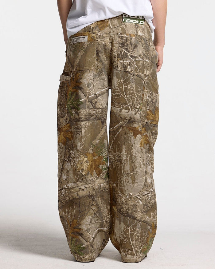 V1 CARPENTER PANTS REALTREE - realtree camo carpenter pants, back view on female model - Cold Culture