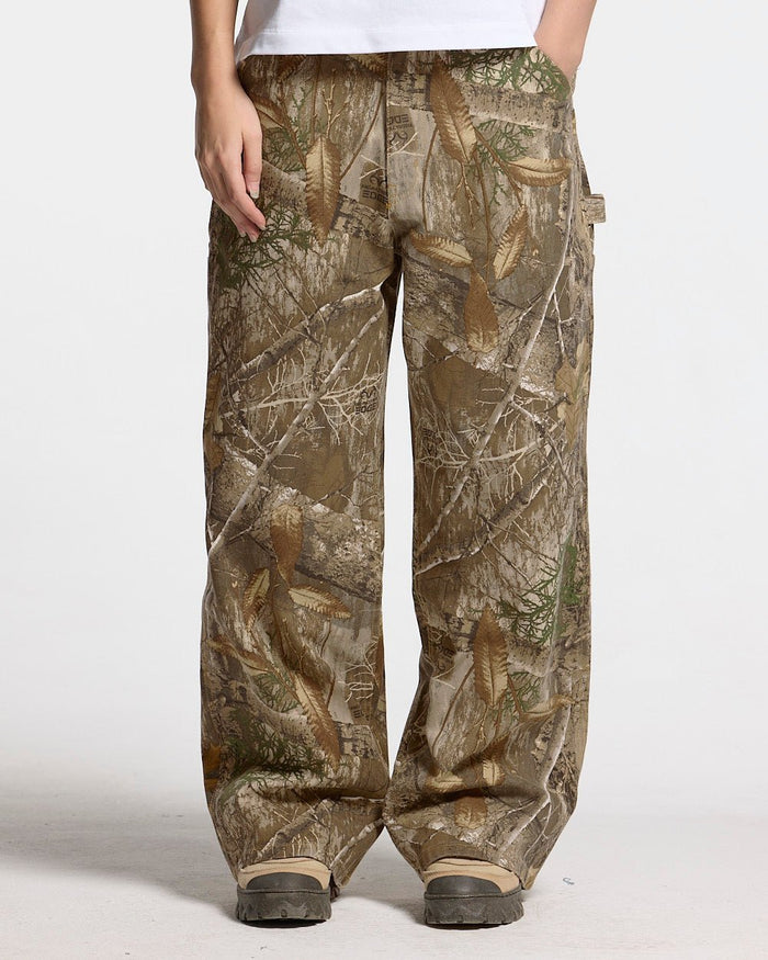 V1 CARPENTER PANTS REALTREE - realtree camo carpenter pants, front view on female model - Cold Culture