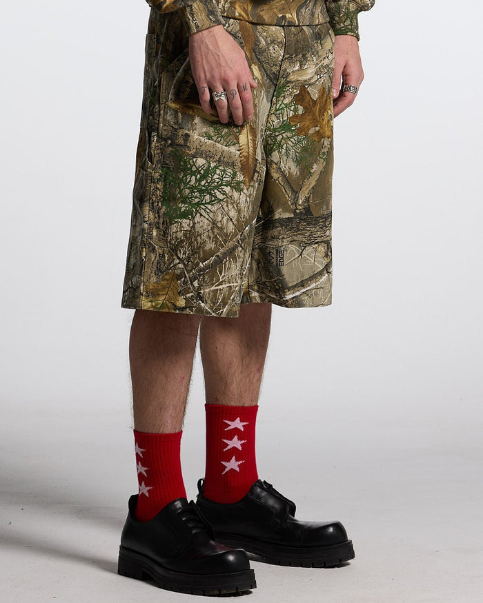 V1 CARPENTER SHORTS REALTREE - realtree camo carpenter shorts, front view on male model - Cold Culture #man