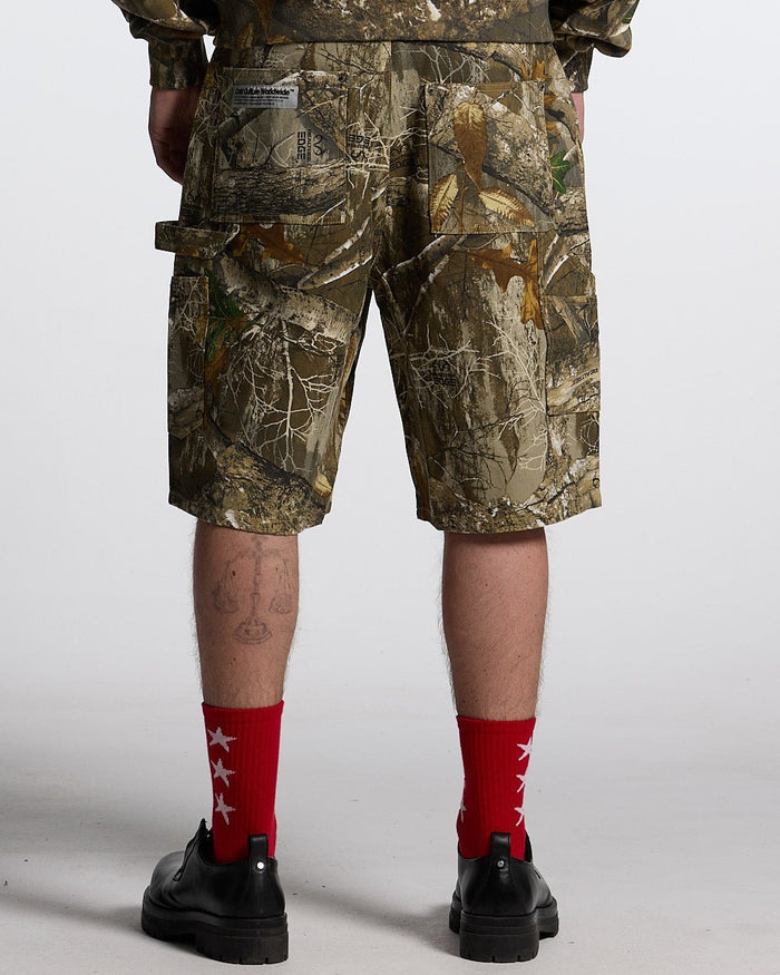 V1 CARPENTER SHORTS REALTREE - realtree camo carpenter shorts, back view on male model - Cold Culture #man
