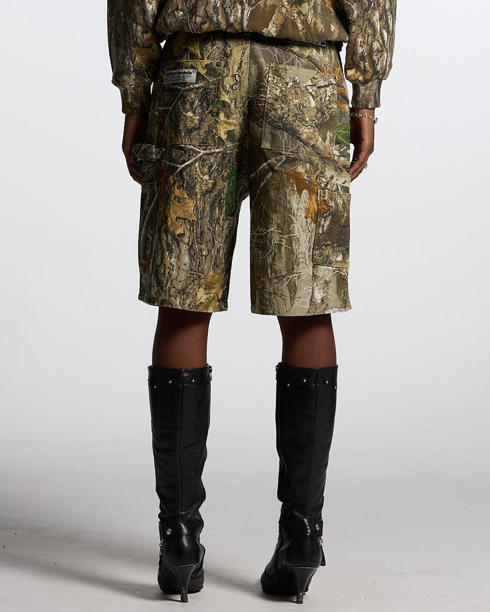 V1 CARPENTER SHORTS REALTREE - realtree camo carpenter shorts, back view on female model - Cold Culture #woman