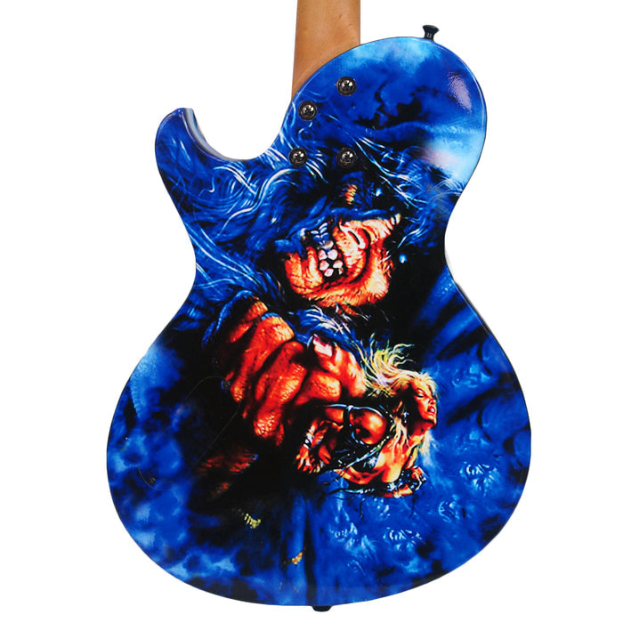 This Limited Edition Doro Guitar features vivid artwork of a grinning, sharp-toothed blue monster clutching a trembling blond figure against a swirling blue background—a true Triumph and Agony Warlock Guitar.