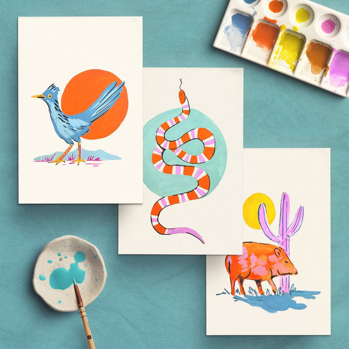 Southwest Animals watercolor cards on a teal background showing a blue bird, striped snake, and desert scenes with a palette.