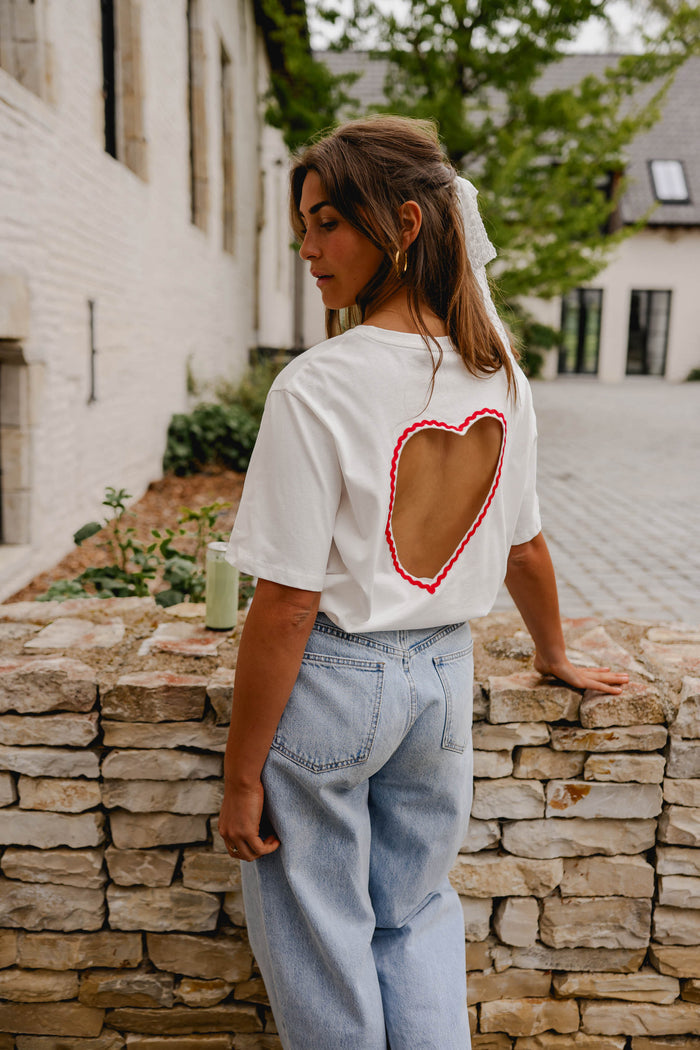 Model wearing white Naya heart cut-out tee