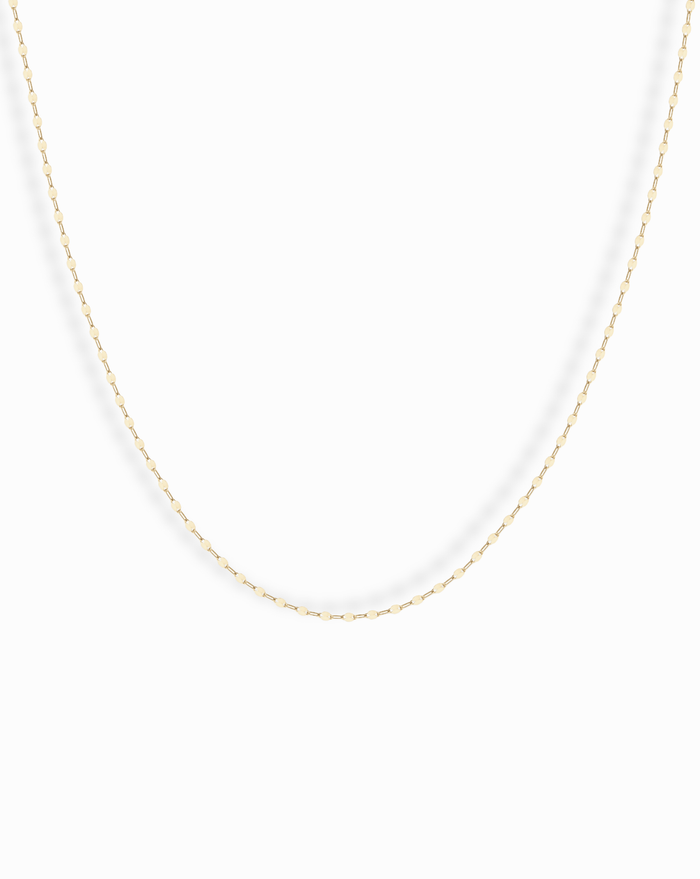 The Winnie Sparkle Chain Necklace features a delicate gold-filled chain with small, evenly spaced oval links for a subtle, elegant look—ideal for layering and displayed beautifully against a white background.