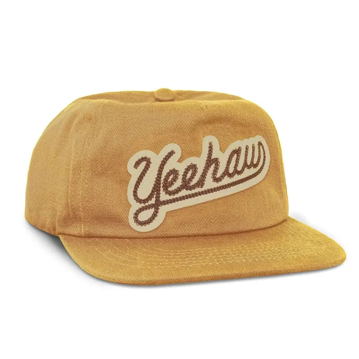 Mustard yellow Yeehaw flatbrim kids hat with a cursive logo patch on the front